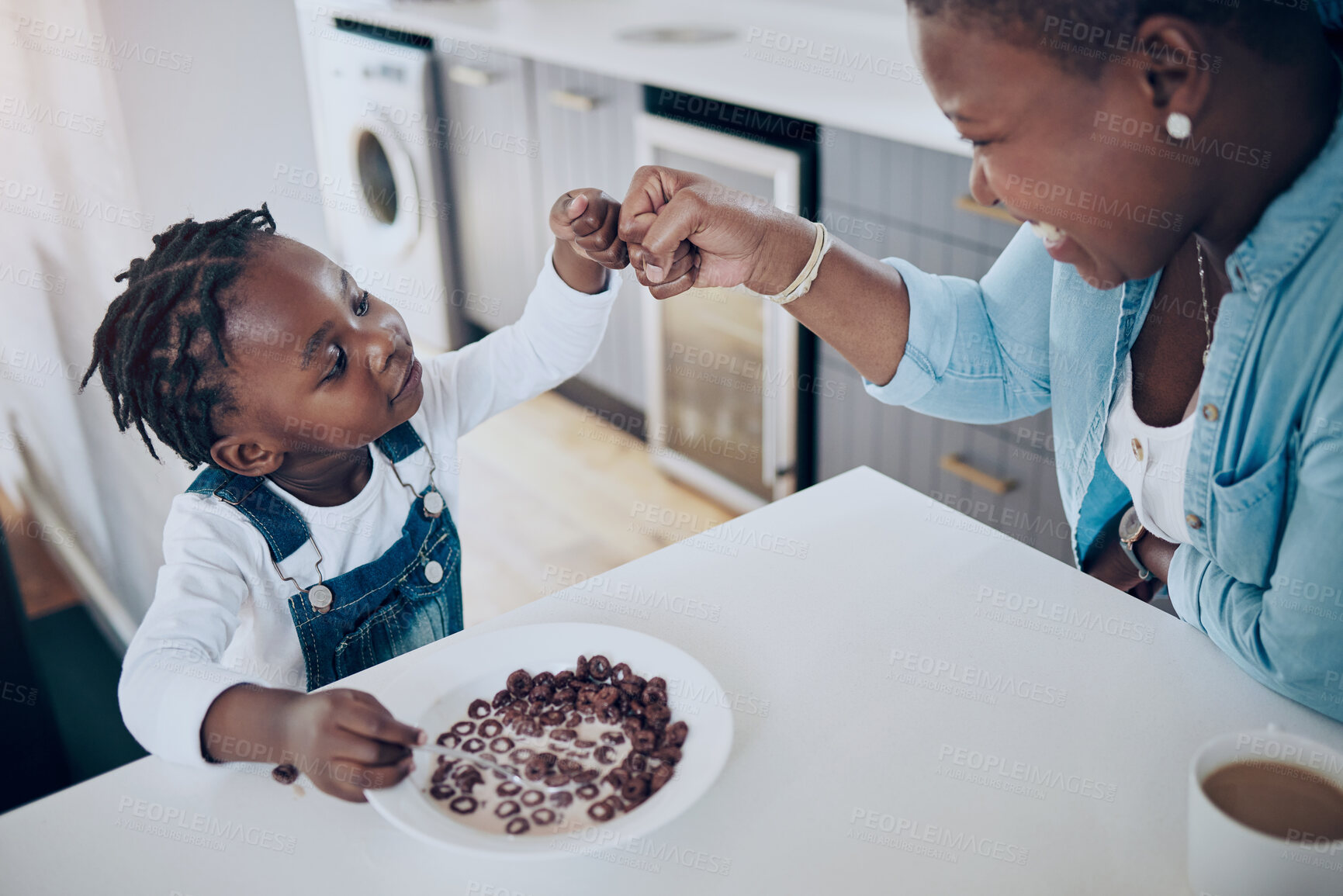 Buy stock photo Love, mother and kid with fist bump in home for bonding, support and child development. Black people, woman and girl with hands together at breakfast for greeting, protection or connection in kitchen