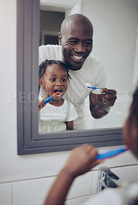 Buy stock photo Shot of a little girl and her father brushing their teeth at home