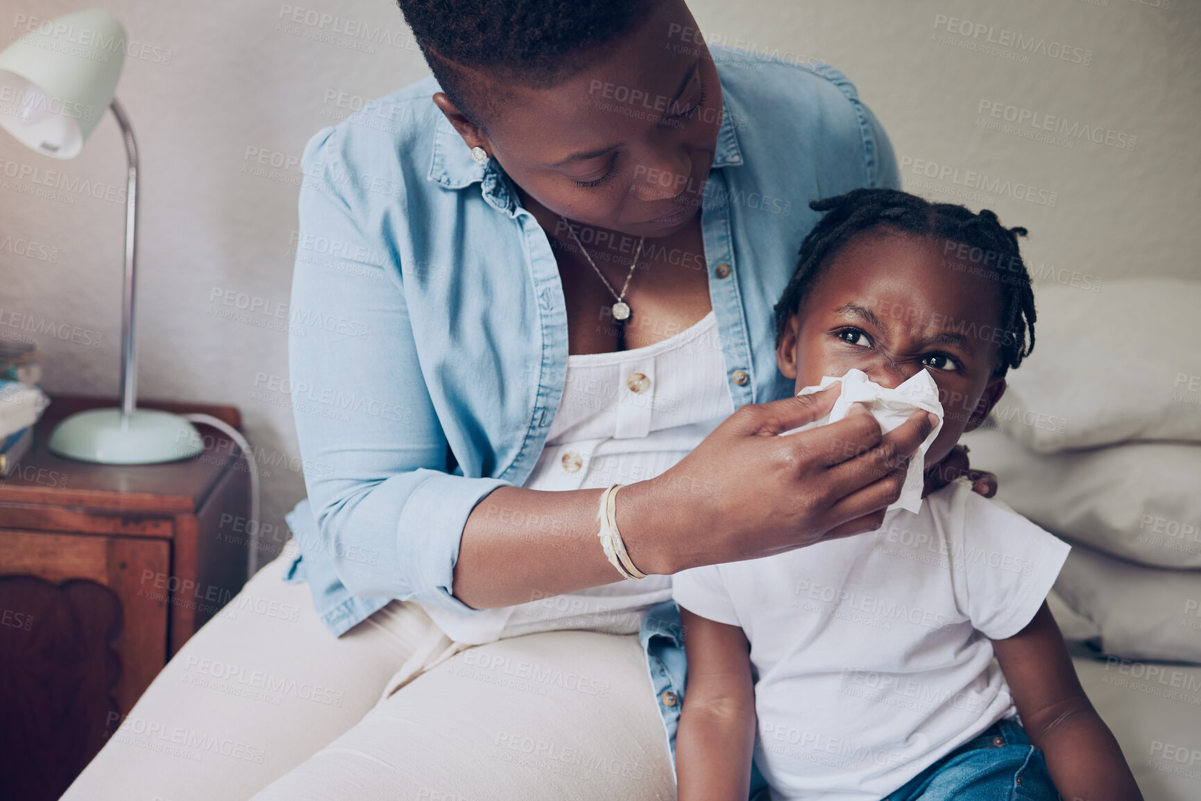 Buy stock photo Black family, mom and blowing nose of child in home, support sick kid and help with nasal infection. Mother, daughter and tissue for respiratory disease in bedroom, illness and allergies or hayfever