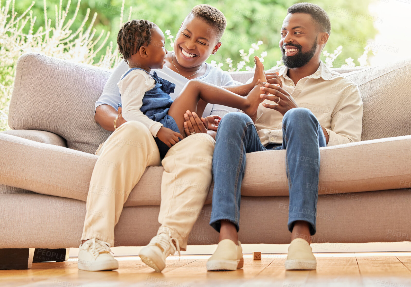 Buy stock photo Black family, happy and child in home on sofa, parents and love for bonding with girl on mothers lap in living room. Apartment, childhood and relationship together on holiday, relax and laughing