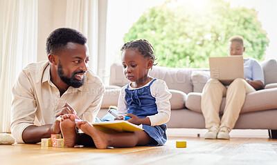 Buy stock photo Shot of a father and daughter drawing together at home