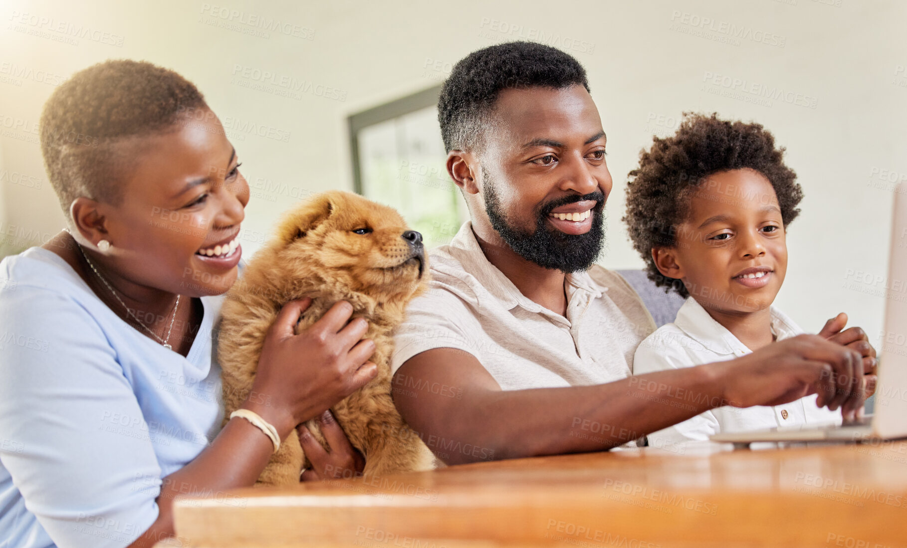 Buy stock photo Shot of a family using a laptop together at home