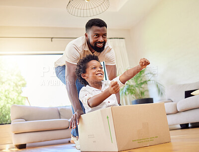 Buy stock photo Father, son and playing at home with pretend car in a box on moving day in new property. Black family, house and real estate move of a dad and child together with play driving and fun in living room