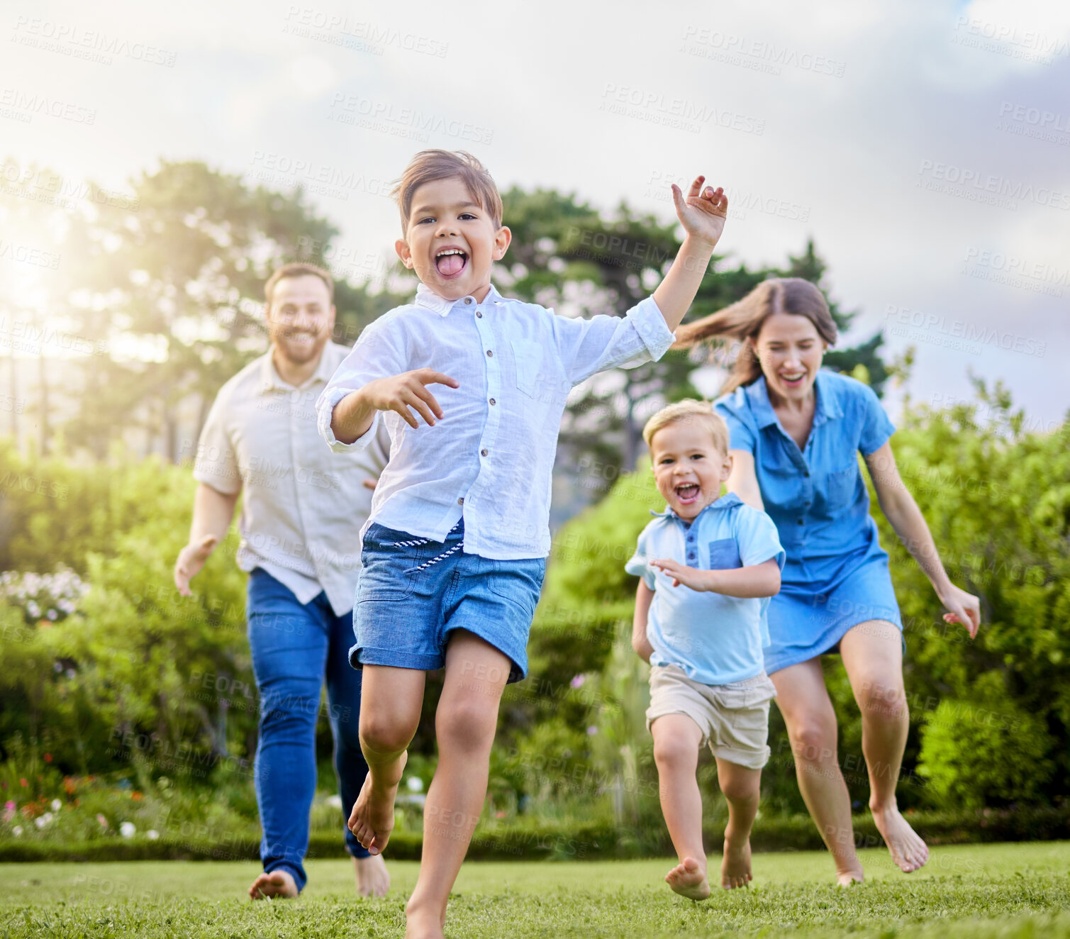 Buy stock photo Energy, race or running with family in park together for summer bonding, fun or games on grass. Excitement, happy or smile with mother, father and children playing outdoor in nature for relationship