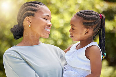 Buy stock photo Love, happy and mother with daughter in nature for bonding,  free time and smile. Happiness, spring and care with black woman holding young girl in outdoor park for weekend, relax and family
