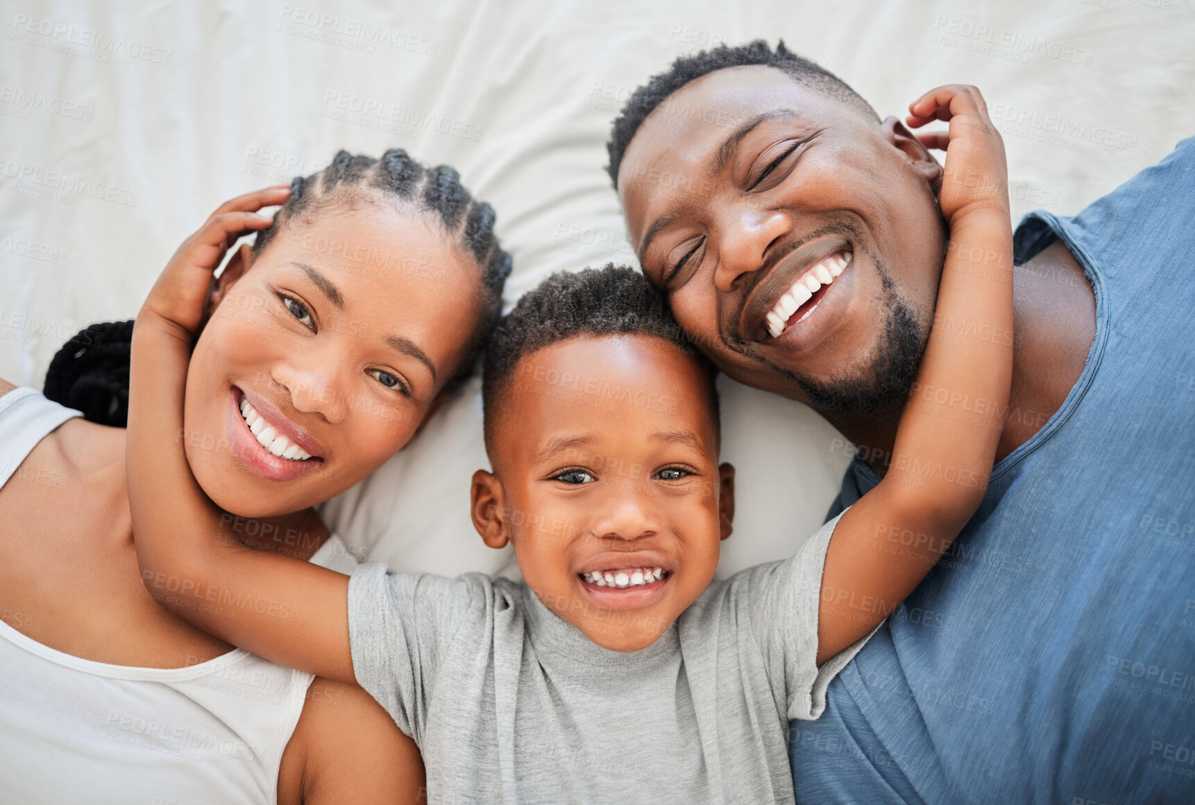 Buy stock photo Top view, bed and portrait of parents with son bonding, happiness and having fun on weekend. African people, black family and mother with father and child posing in bedroom to relax in morning