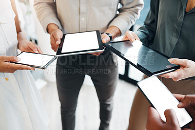 Buy stock photo Cropped shot of an unrecognisable group of businesspeople standing together and using technology