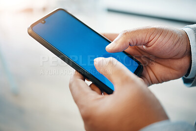 Buy stock photo Cropped shot of an unrecognisable businessman standing alone in the office and using his cellphone