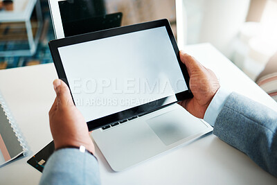 Buy stock photo Cropped shot of an unrecognisable businessman sitting alone in the office and using a digital tablet