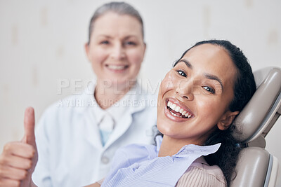 Buy stock photo Shot of a mature dentist and her young patient giving the thumbs up