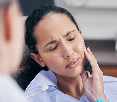 Buy stock photo Shot of a young woman in pain at her dentists office