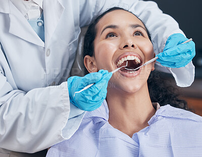 Buy stock photo Shot of a young woman having a procedure performed by her dentist