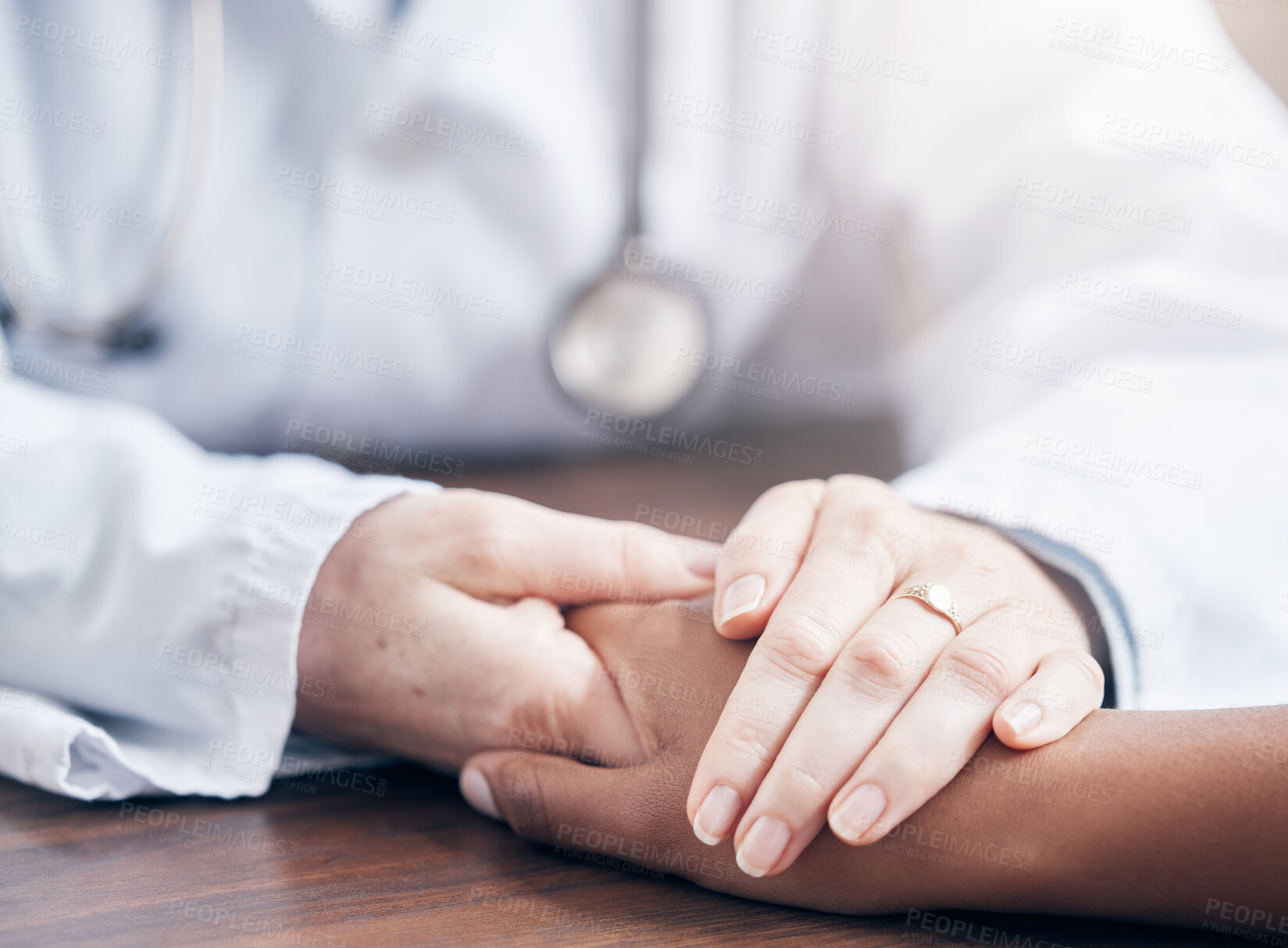 Buy stock photo Doctor, patient and hands for support on desk at office, empathy or trust at hospital. Palms, care and health with man and woman in clinic, together for kindness or helping others with cancer or pain