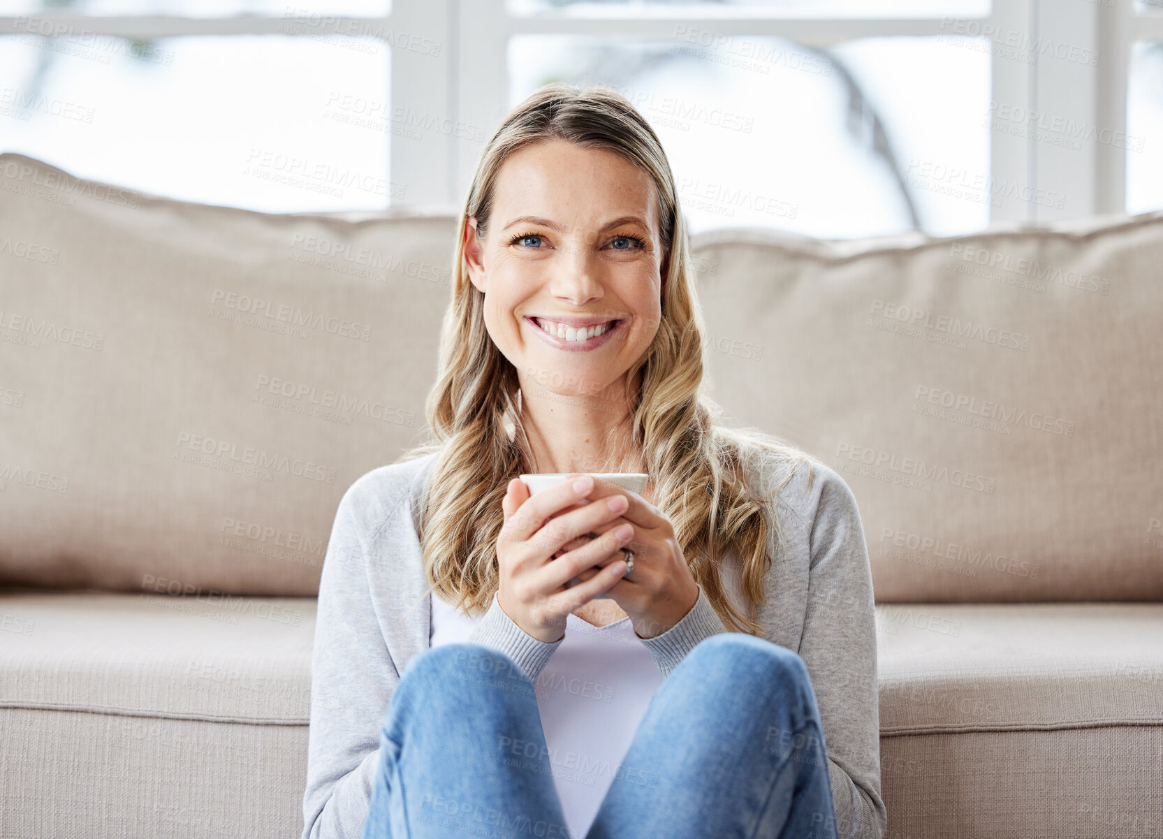 Buy stock photo Portrait, relax and happy woman in home drinking coffee with smile for peace, wellness or break in lounge. Couch, confident or calm female person with tea cup for caffeine beverage in cosy house