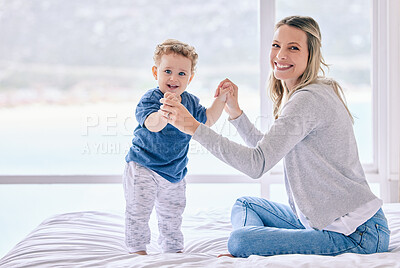 Buy stock photo Shot of a woman bonding with her baby boy at home