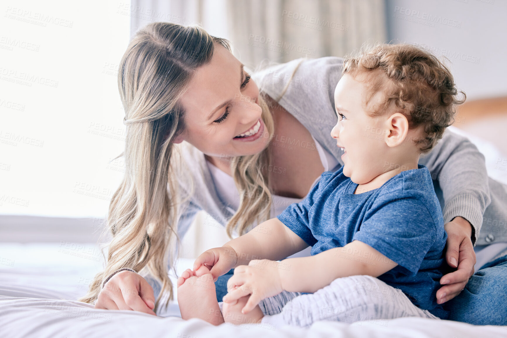 Buy stock photo Shot of a mom bonding with her adorable baby boy at home