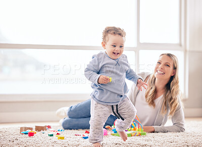 Buy stock photo Shot of a mom sitting with her son while he plays with her toys