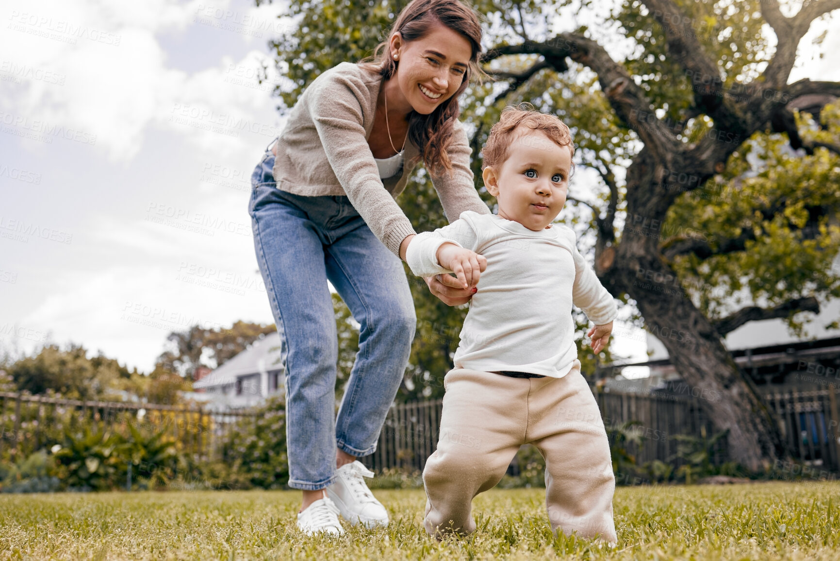 Buy stock photo Mother, boy and helping to walk in outdoor, practice and support for growth or mobility development. Mommy, son and teaching child to balance or holding hands for progress, backyard and first steps