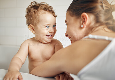 Buy stock photo Shot of a mother bathing her son at home