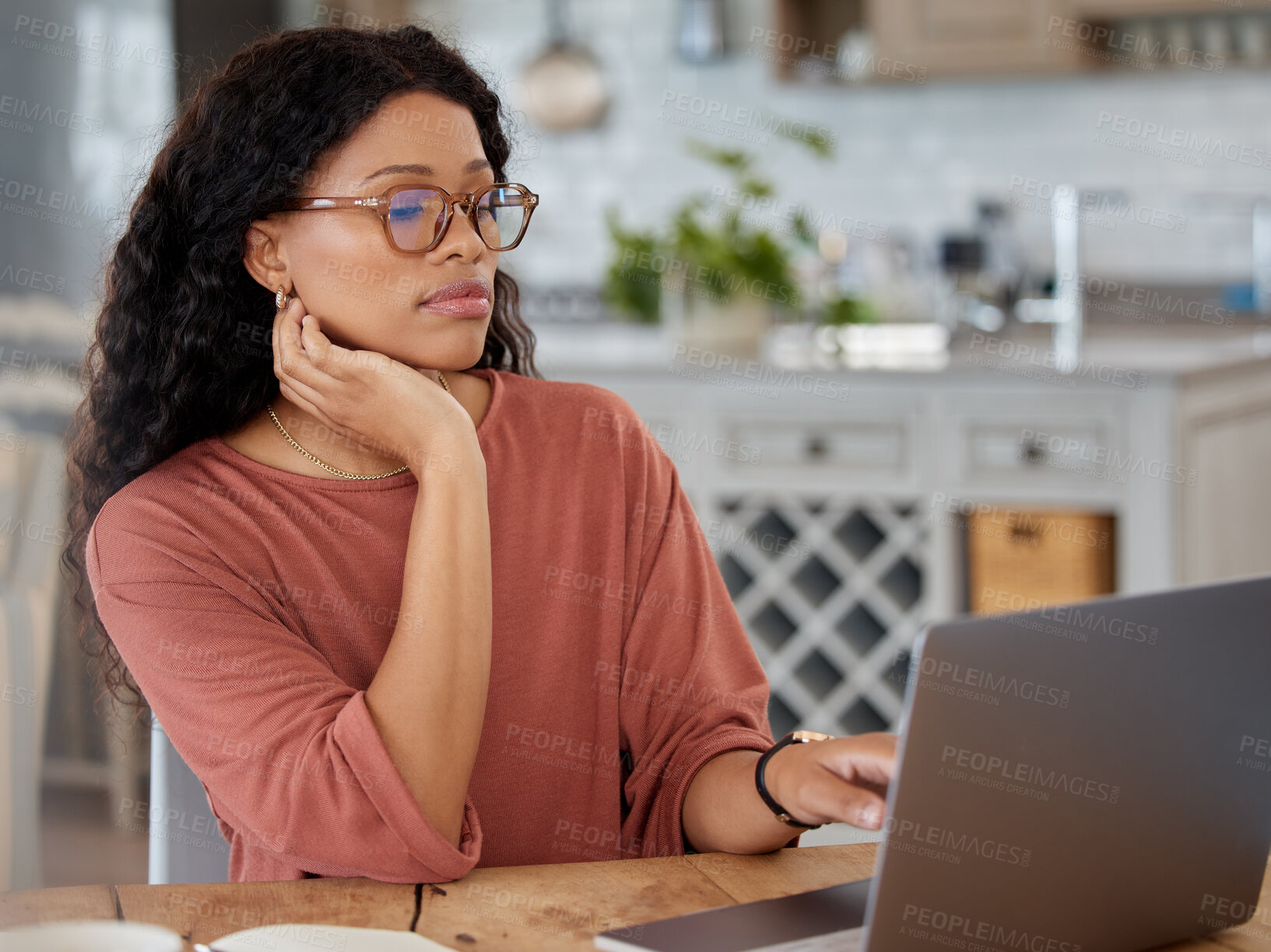 Buy stock photo Shot of a young woman working on a laptop at home