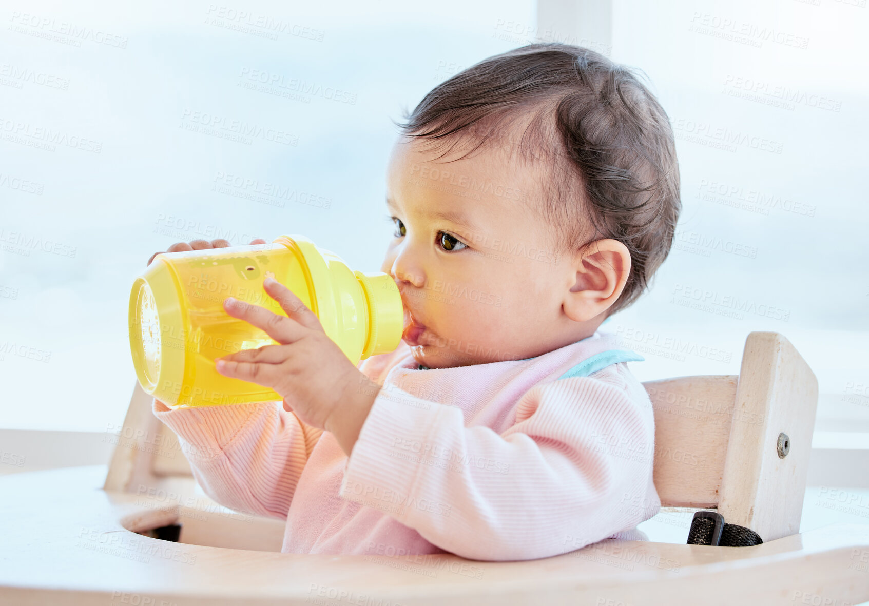 Buy stock photo Girl, baby and drink with bottle in feeding chair for nutrition, growth or formula for health in family home. Infant, child and care for milk, juice or water for development with wellness in morning