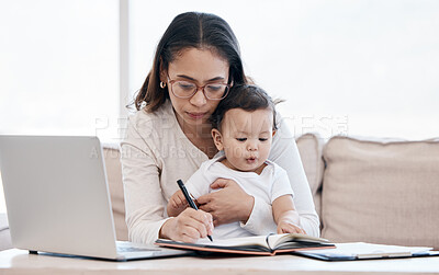 Buy stock photo Shot of a young mother caring for her baby girl while working from home