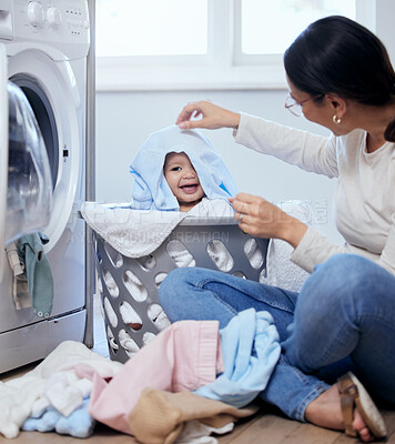 Buy stock photo Laundry, mom and baby in basket with playing, bonding and child development with toddler in home. Housekeeping, happy mother and infant girl together with clothes, washing machine and cleaning games