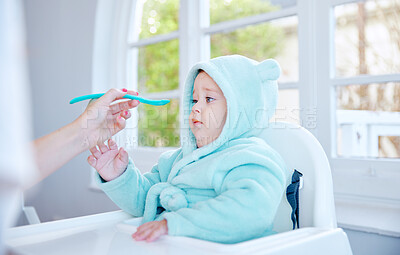 Buy stock photo Baby, mother and disgust in feeding chair with food, helping hand and spoon for health, nutrition and care in family home. Infant child, parent and support with lunch, bonding and connection in house