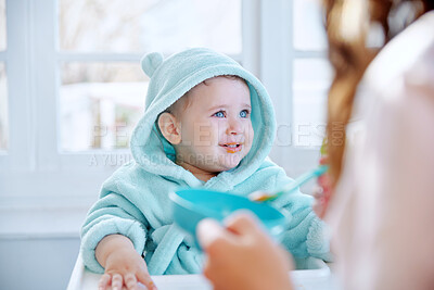 Buy stock photo Baby, mother and smile in feeding chair with food, helping hand and spoon for health, nutrition and care in family home. Infant child, parent and happy with eating, bonding and breakfast in house