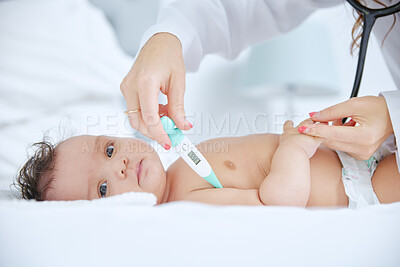 Buy stock photo Shot of a little baby having her temperature measured by a doctor