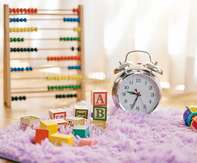 Buy stock photo Still life shot of a clock and multiple toys on a fluffy mat