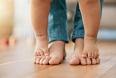 Buy stock photo Shot of a baby standing on her mother's feet