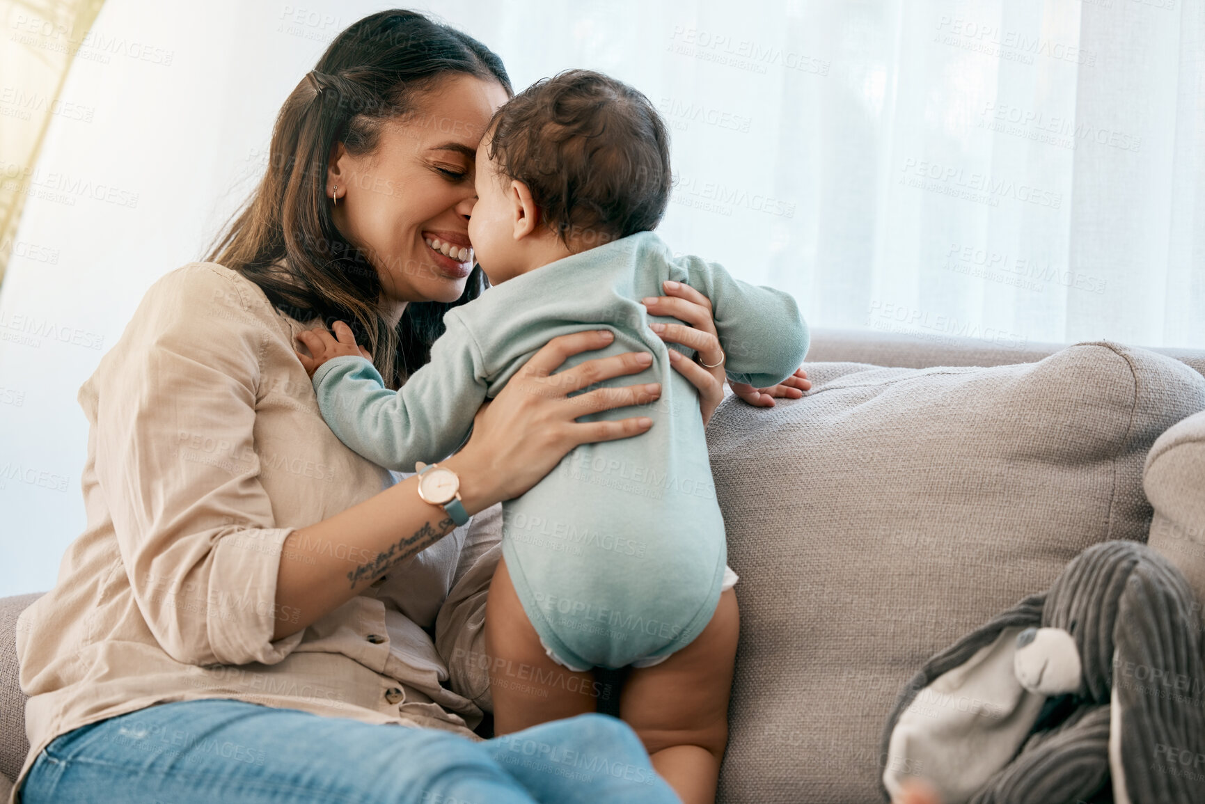 Buy stock photo Love, happy and mother with baby on a sofa for playing, games and laughing in their home together. Family, smile and mom with girl toddler on a couch, relax and bonding, fun and hug in a living room