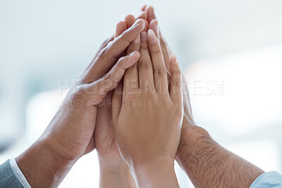 Buy stock photo Shot of a group of business people doing a high five in a office