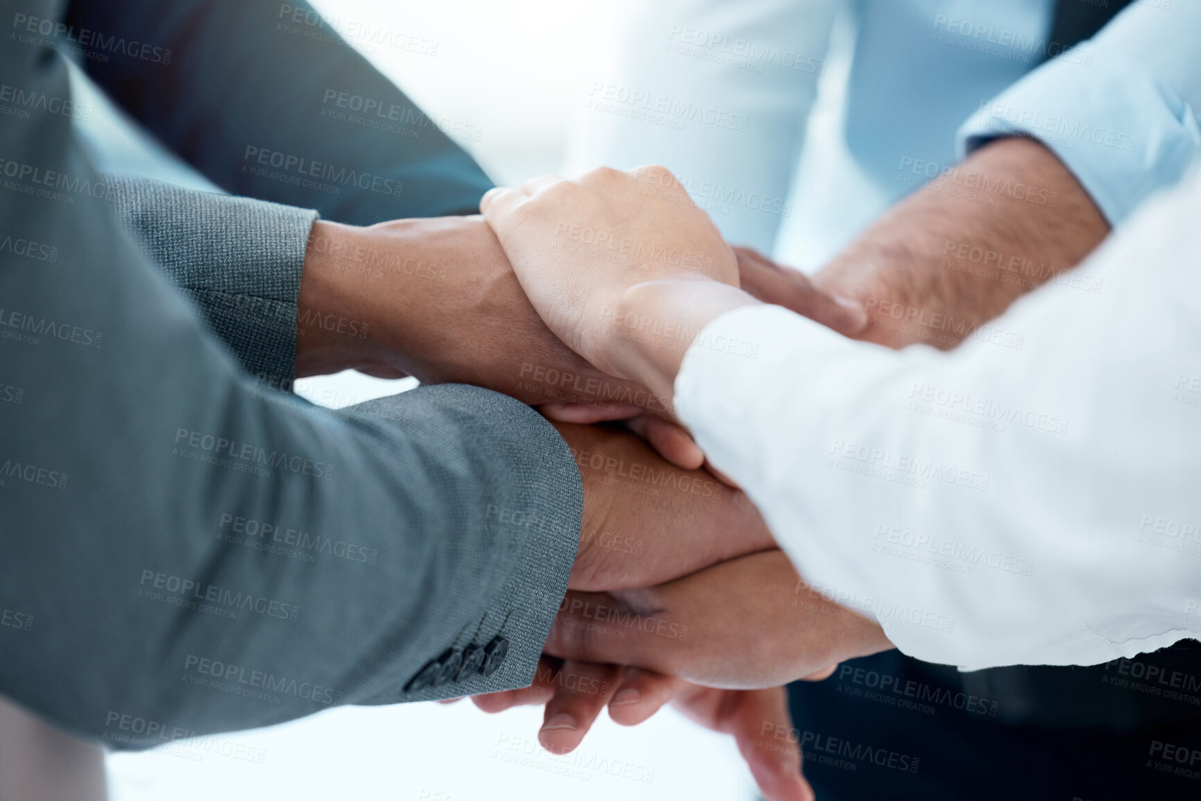 Buy stock photo Shot of a team of business people stacking their hands in motivation