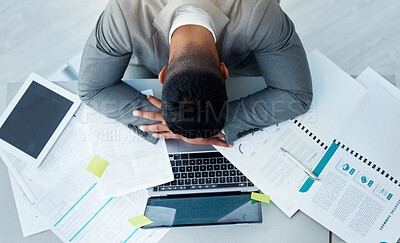 Buy stock photo High angle shot of a young businessman sleeping at his desk in an office