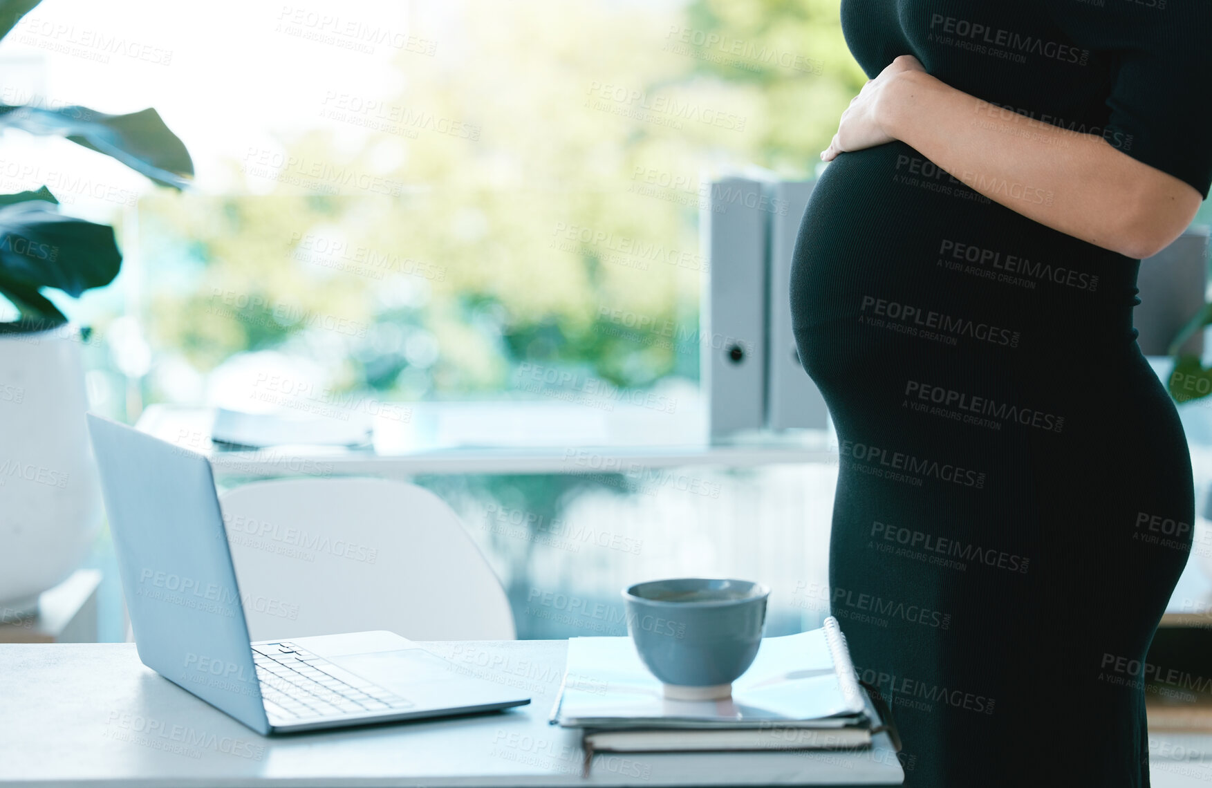 Buy stock photo Closeup shot of a pregnant businesswoman working in an office