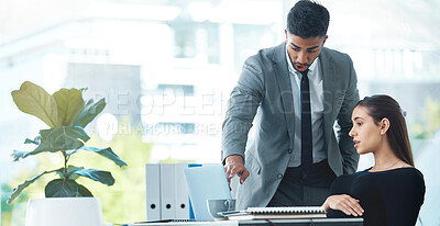 Buy stock photo Shot of two businesspeople working together on a laptop in an office