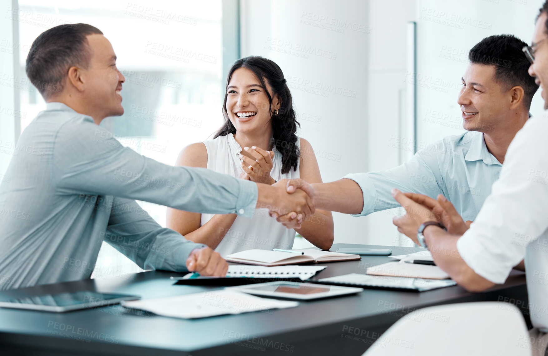 Buy stock photo Shot of businesspeople shaking hands during a meeting in an office