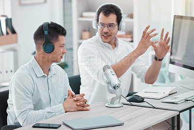 Buy stock photo Shot of two young men doing a broadcast in an office