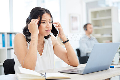 Buy stock photo Shot of a young businesswoman looking stressed out while talking on a cellphone in an office