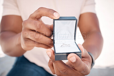 Buy stock photo Shot of an unrecognizable man proposing to his girlfriend at the beach
