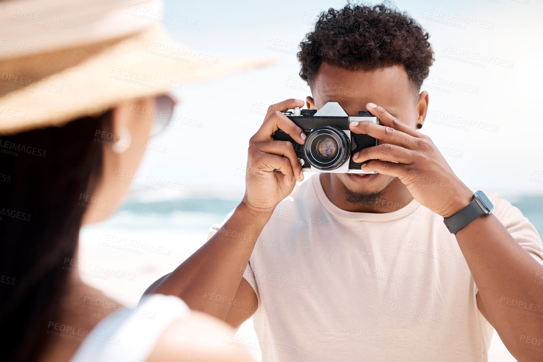 Buy stock photo Man, camera and woman on beach for photography, vacation and couple in holiday resort. Male photographer, romance and girl in nature for love, date or anniversary memory with vintage tech for picture