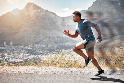 Buy stock photo Shot of a handsome young man running alone outdoors