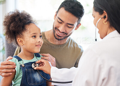 Buy stock photo Shot of a little girl sitting on her father's lap while being examined by her doctor
