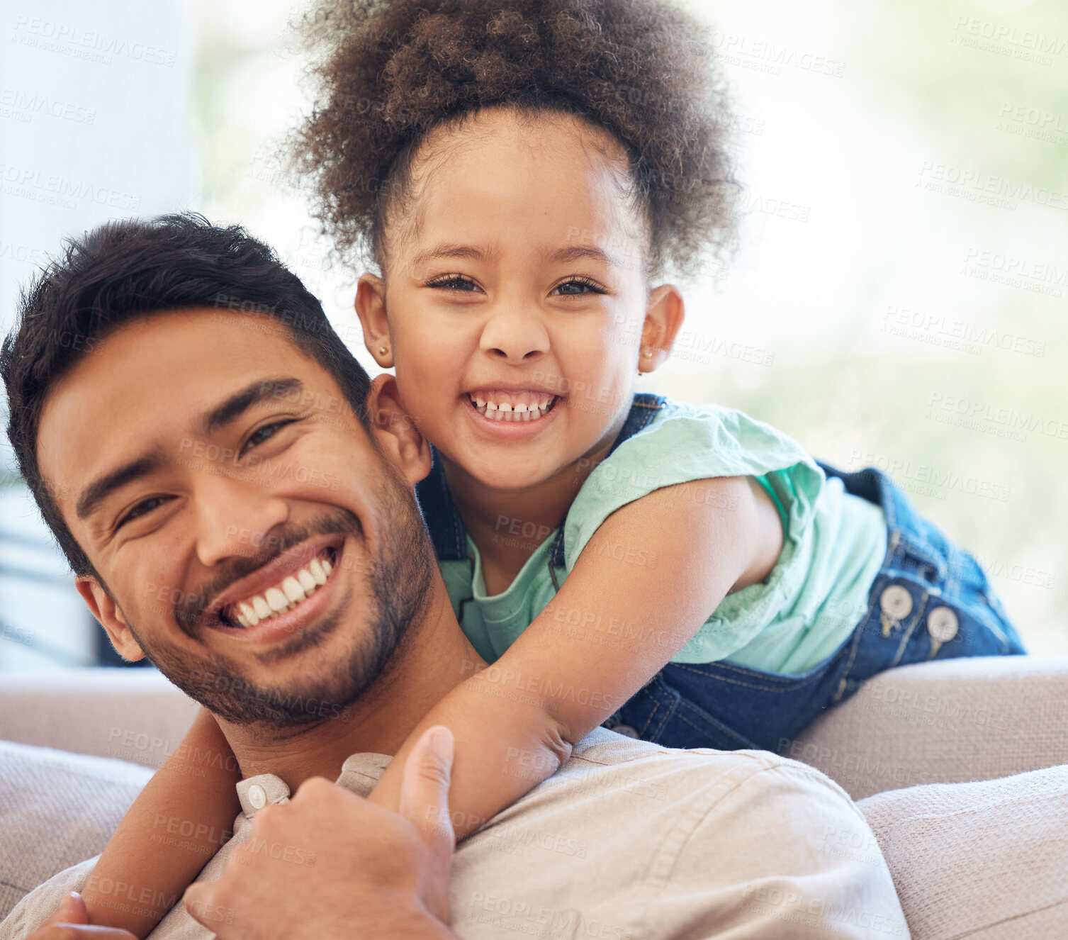 Buy stock photo Cropped portrait of an handsome young man and his adorable little daughter in the living room at home