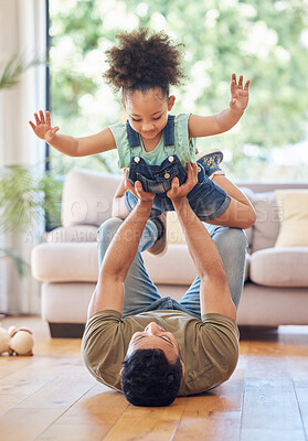 Buy stock photo Full length shot of an adorable little girl playing with her day on the living room at home
