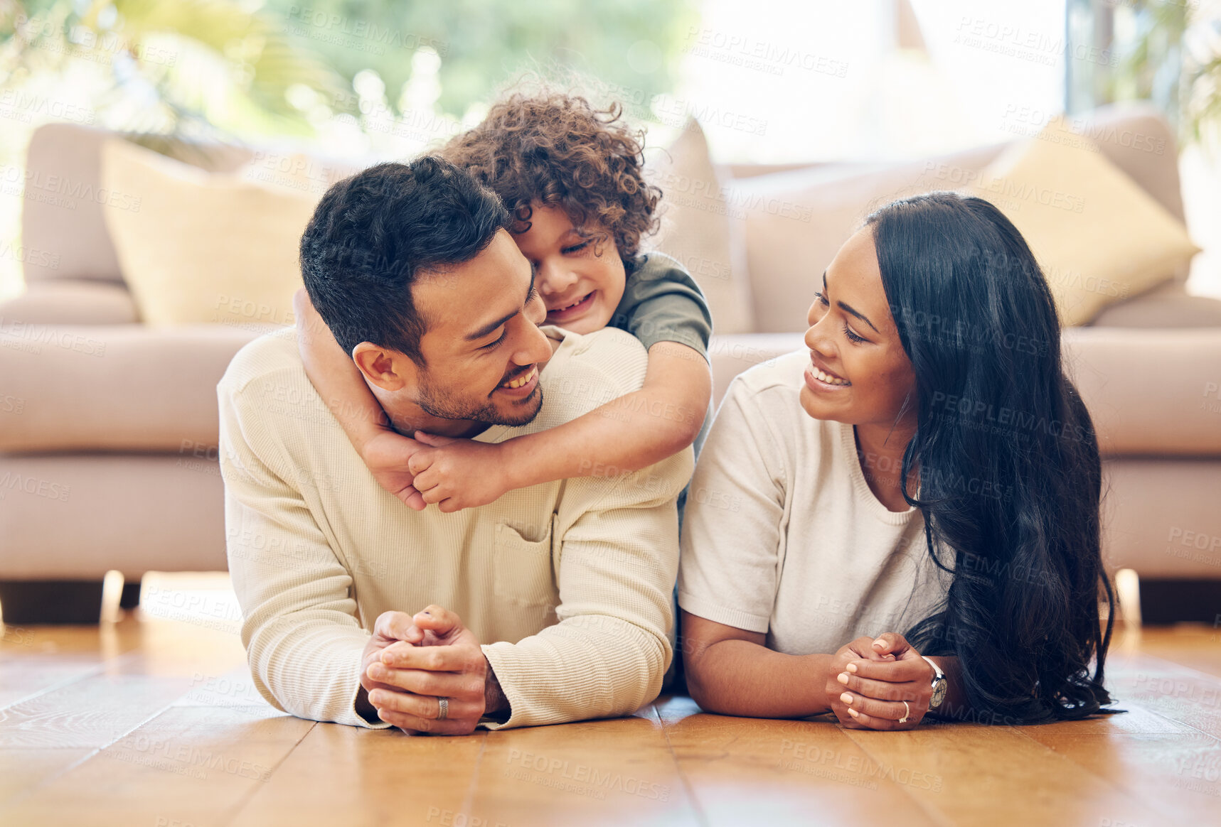 Buy stock photo Family, parents and child with hug on floor for bonding, connection or relax together in living room. Smile, young kid and happy man with woman playing for love, embrace or care in home on weekend