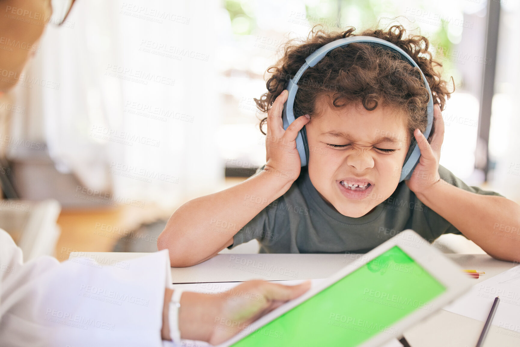 Buy stock photo Boy, headphones and doctor or tablet for stress test, autism diagnosis and sensory overwhelmed. Male person, child and audio or sound for anxiety or pain, online and green screen and psychologist