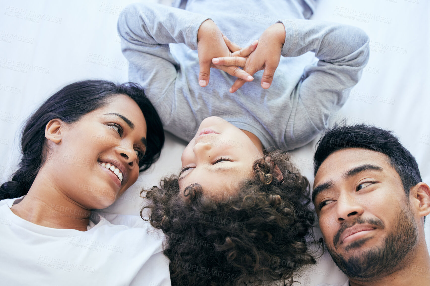 Buy stock photo Shot of a couple bonding with their son at home